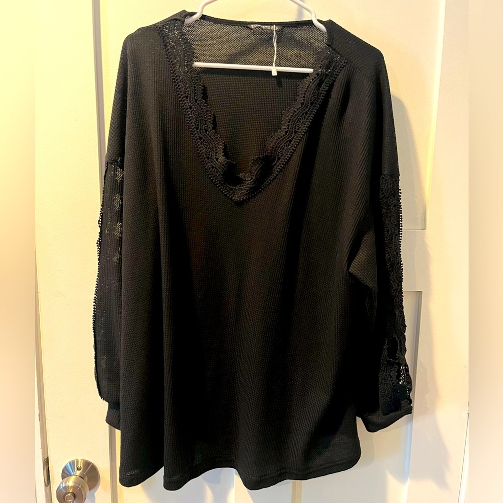 Waffle knit shirt with lace inset sleeves.